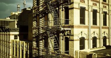 CGI Historic building with fire escape under cloudy sky in an urban setting video