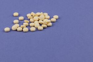 Yellow tablets scattered on a blue surface photo