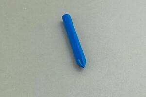 Crayon rolls and bounces on a smooth surface in this photo