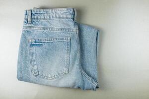 Casual blue denim jeans folded neatly on a flat surface photo