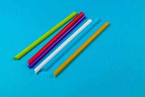 Colorful straws on a blue background for creativity photo