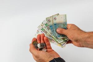 Counting cash in hands with various bills and coins photo