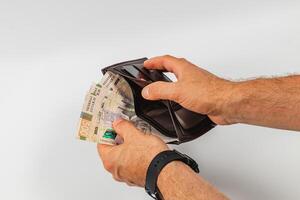 Holding a wallet with cash inside during a financial transaction photo