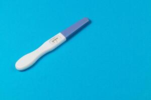 Pregnancy test on a blue background ready for results photo