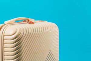 Stylish suitcase against a bright blue background photo
