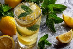 Refreshing cold lemonade with mint and lemon slices in glass photo