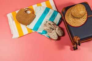 Packing for a beach vacation with essentials on colorful backdrop photo