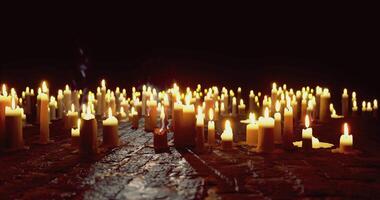 CGI Warm glow of numerous candles illuminating a dark space at night video