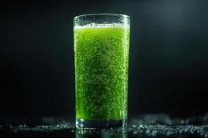 a glass of green juice on a black background photo