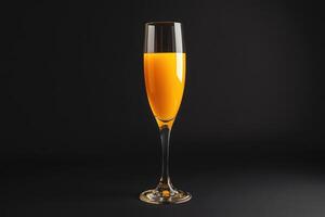 orange juice in a glass on a black background photo