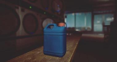 CGI Blue container resting on wooden table in a dimly lit laundry room video