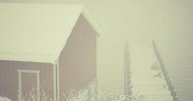 CGI Snow covered cabin and dock on a misty winter day by the lake video