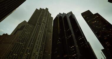 CGI Skyscrapers tower high above the city under a moody sky at dusk video
