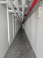 Industrial Pipework and Modern Flooring in a Long Corridor Space photo