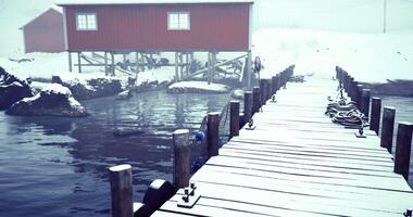 CGI Winter dock view with red building and snowy landscape by the water video