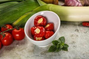 A bowl of tomatoes, onions, garlic, and other vegetables photo