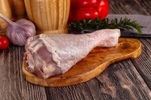 Raw meat on a wooden cutting board with vegetables and spices photo