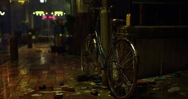 CGI Urban night setting with abandoned bicycle and wet pavement in rainy weather video