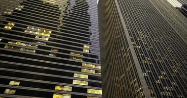 CGI Skyscrapers with illuminated windows in urban environment at dusk video