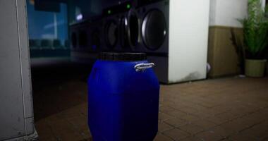 CGI Blue container placed in a laundromat with washing machines in the background video