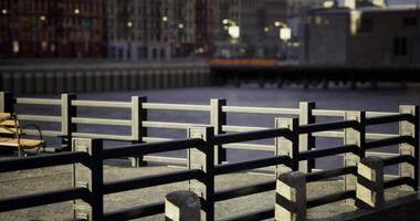 CGI City waterfront promenade with railing and bench during sunset hours video