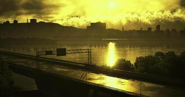 CGI Golden sunset reflection over river with city skyline and highway video
