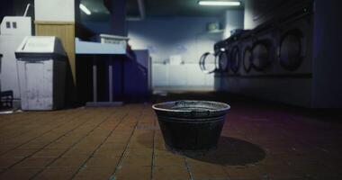 CGI Empty bucket sits in an abandoned laundromat during late night hours video