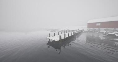 CGI Foggy winter morning at a secluded dock near a snowy cabin video