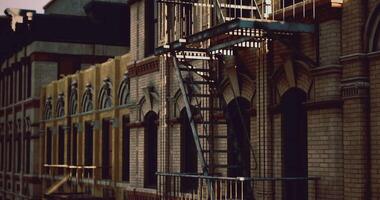 CGI Historic brick building with fire escape in urban setting during golden hour video