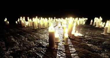CGI Candles illuminate dark space creating a serene, reflective atmosphere video