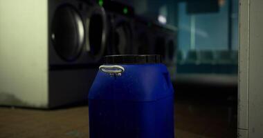 CGI Blue container sits in a laundromat with washing machines in the background video