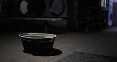 CGI Black basin placed in a dimly lit laundromat with a quiet atmosphere video