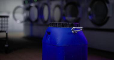 CGI Large blue container positioned inside a modern laundromat during evening hours video