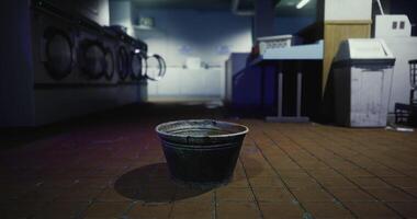 CGI Empty bucket in quiet laundromat late at night during cleaning hours video