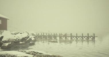 CGI Snowy dock by a quiet lake in a foggy winter landscape video