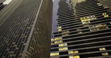 CGI Skyscrapers illuminated at dusk reflecting urban architecture video