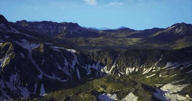 CGI Majestic mountain range with snow covered peaks and green valleys in daylight video