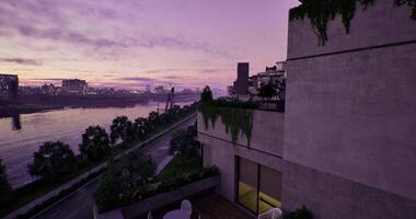 CGI Captivating sunset view over a river from a modern balcony in an urban setting video