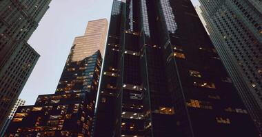 CGI Modern skyscrapers illuminated at dusk in an urban setting video