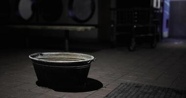 CGI Bucket sits alone in a dimly lit laundry room during late hours video