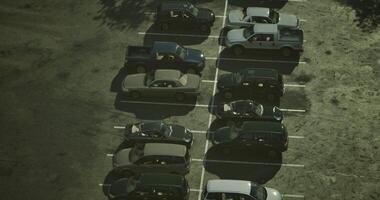CGI Cars park in a structured layout at a parking lot in the afternoon sun video
