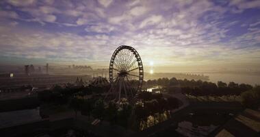 CGI Evening view of a ferris wheel and amusement park under a colorful sky video