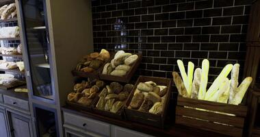 CGI Freshly baked bread displayed in a bakery with wooden racks and black tiles video