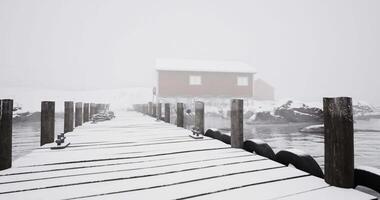 CGI Snowy dock leads to red cabin in foggy winter landscape video