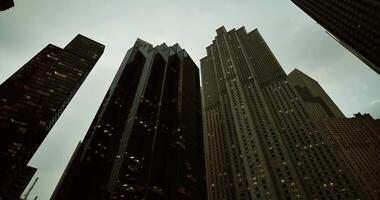 CGI Skyscrapers loom over the cityscape under a cloudy sky at dusk video