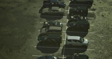 CGI Multiple parked vehicles in a busy lot during midday in a suburban area video