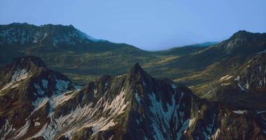 CGI Mountains rise majestically under a clear sky in a remote landscape video