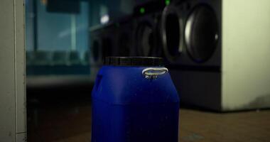CGI Washing machine area features a blue container near the laundry machines video