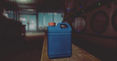 CGI Cleaning solvent container placed on a table in a dimly lit laundry room video