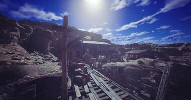 CGI Old mining town under bright sky with wooden structures and rocky terrain video